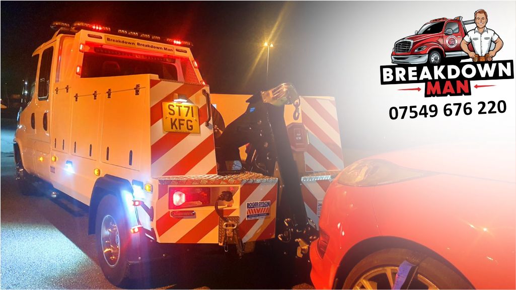 Simon towing a red car at night with branded truck.